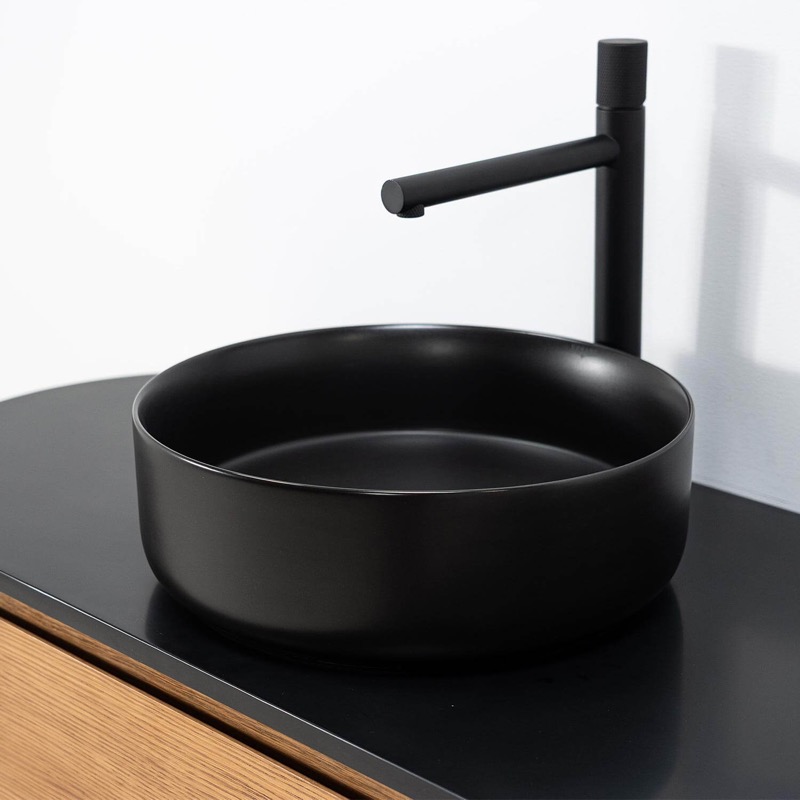 Svart minimalistisk tvättställ med svart modern blandare Svart minimalistisk tvättställ med svart modern blandare